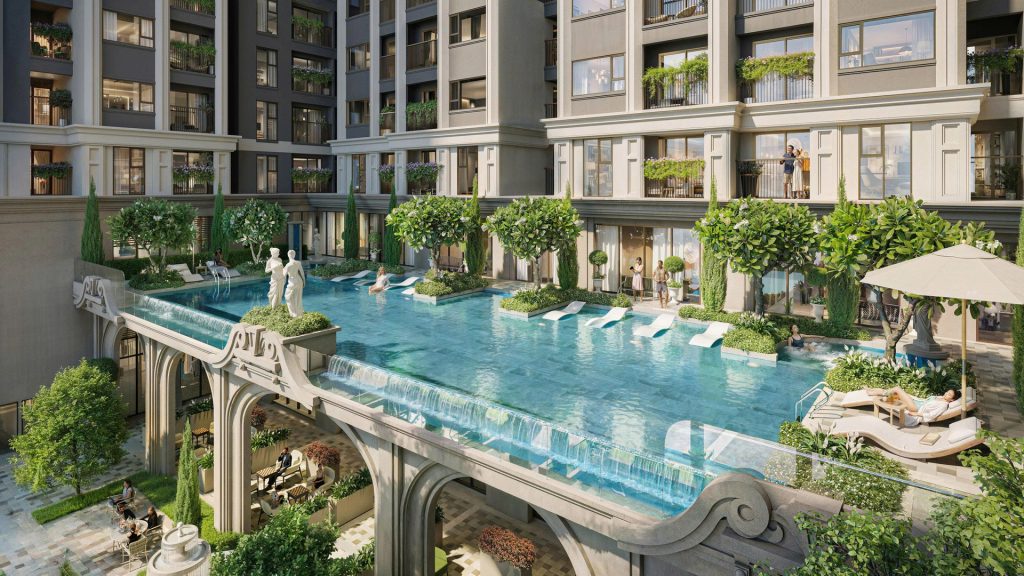 Bể bơi nội khu Moonlight 2 với ghế tắm nắng và sân vườn giữa hai tòa tháp